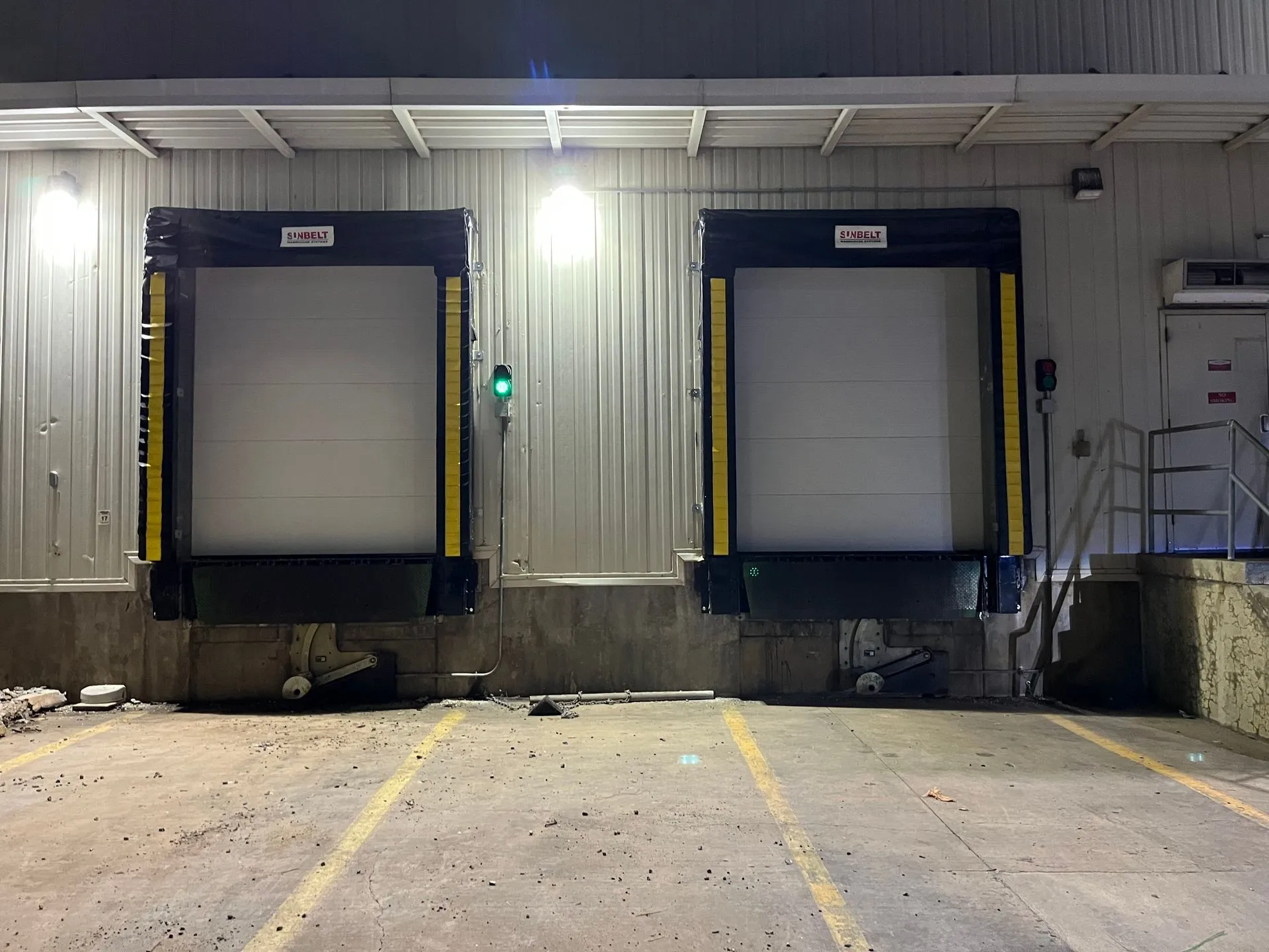 Two white commercial dock station garage doors