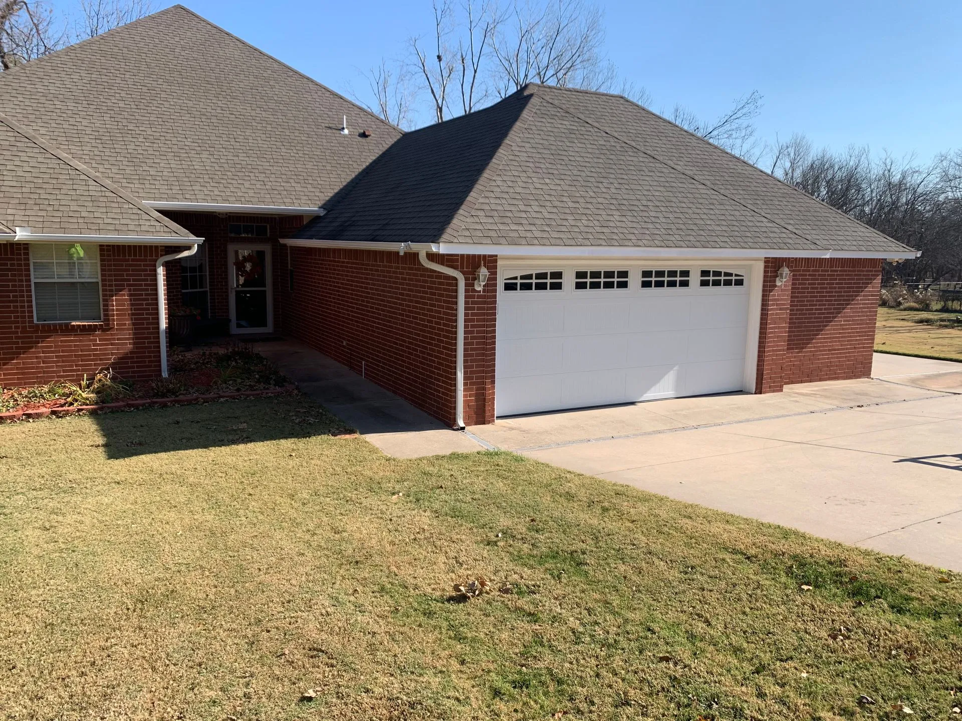 White garage door installed on a brick Oklahoma City home